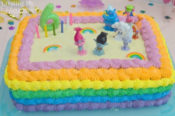 our colorful trolls birthday cake with figurines